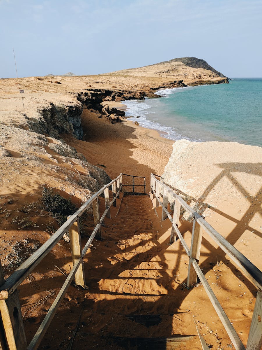 Wooden staircase leading to a stunning beach at Cabo de la Vela, Colombia.